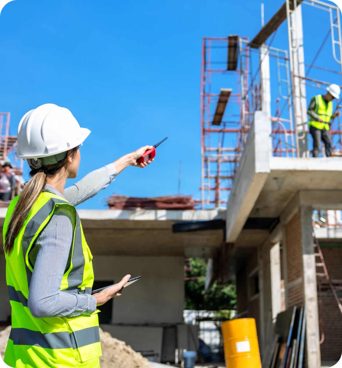 Construction workers communicating on building site.